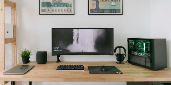 black flat screen computer monitor on brown wooden desk