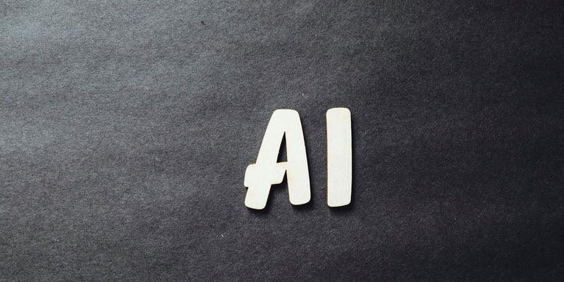 the word ai spelled in white letters on a black surface