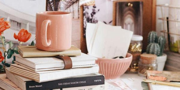 brown ceramic coffee mug on book