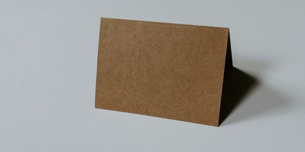 brown hardbound book on white surface